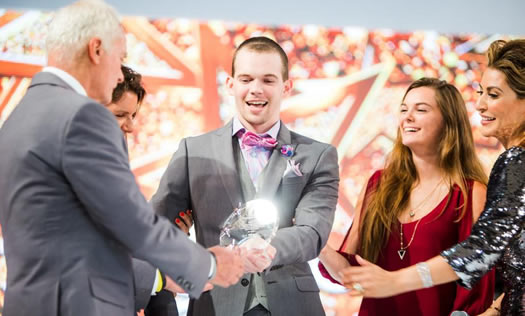 Adam Rosen receiving an award