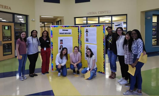 Teenagers in front of presentation board