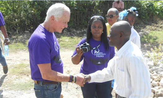 Harris Rosen shaking hands with man in Haiti