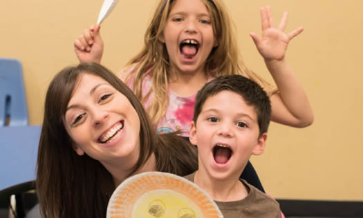 Kids with helper making faces