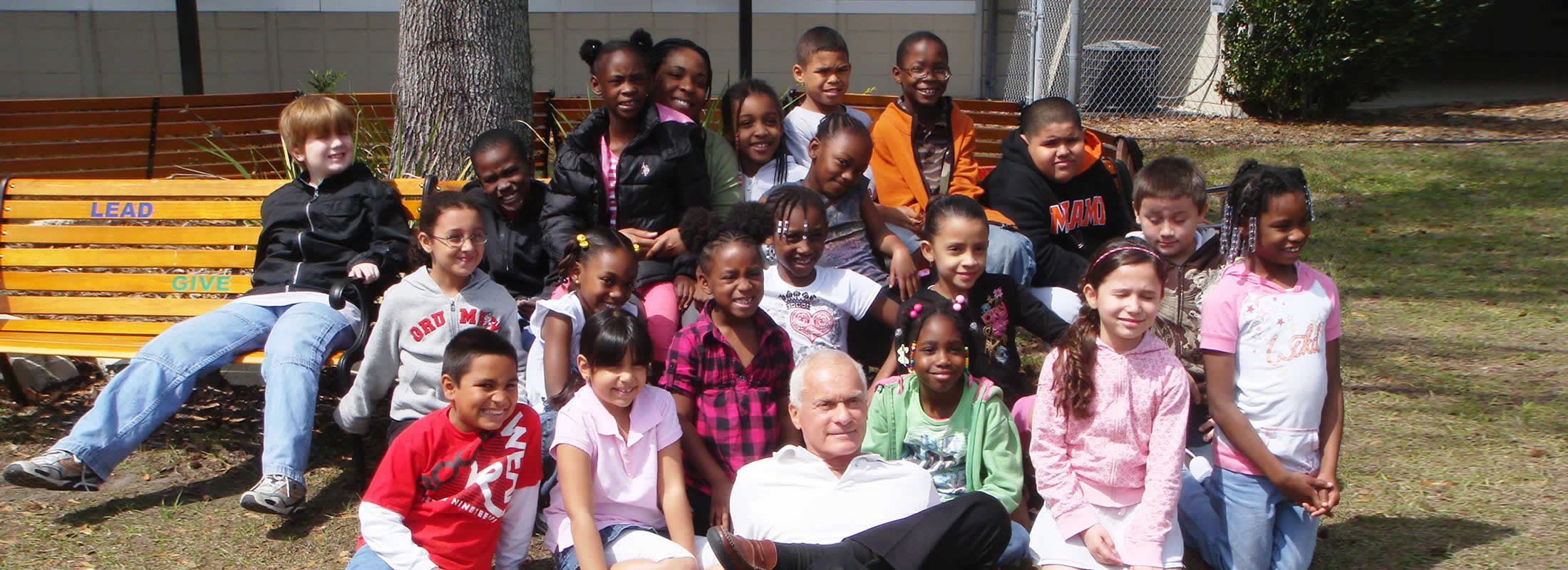 Harris Rosen sitting with kids outside