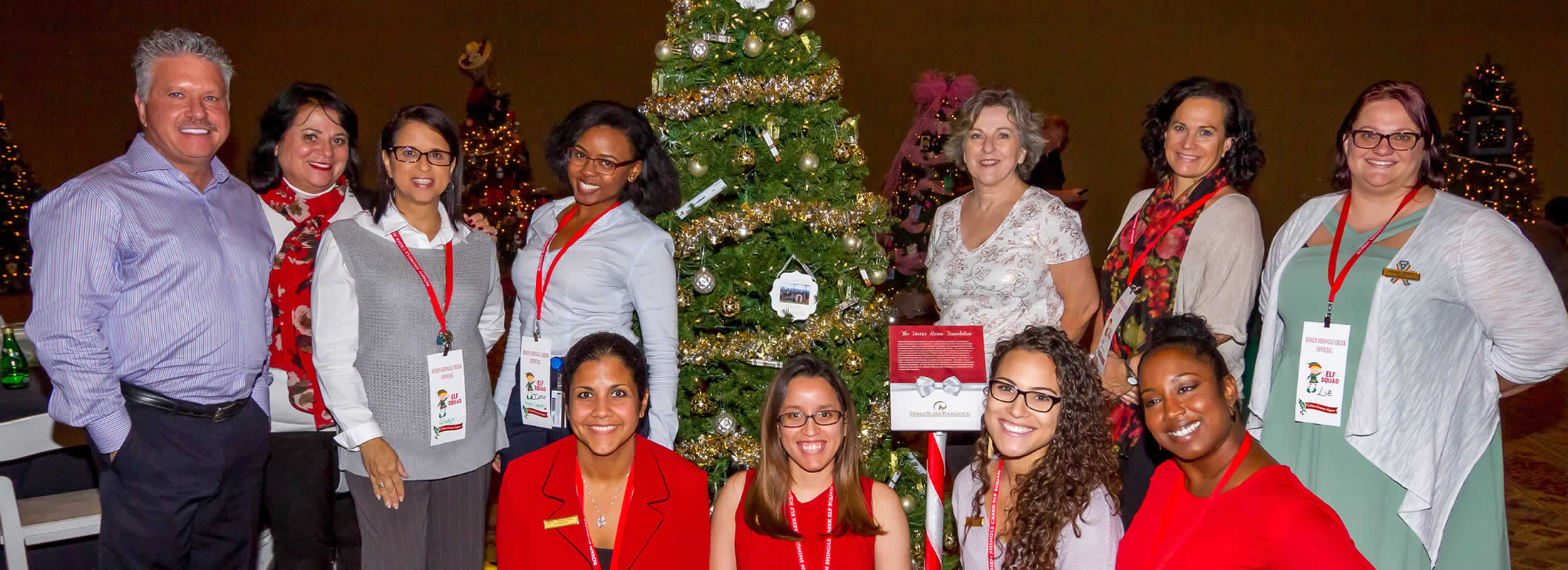 Staff in front of Christmas Tree