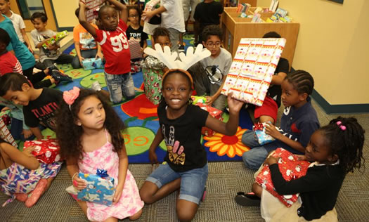 Kids with christmas presents - Tangelo Park Program